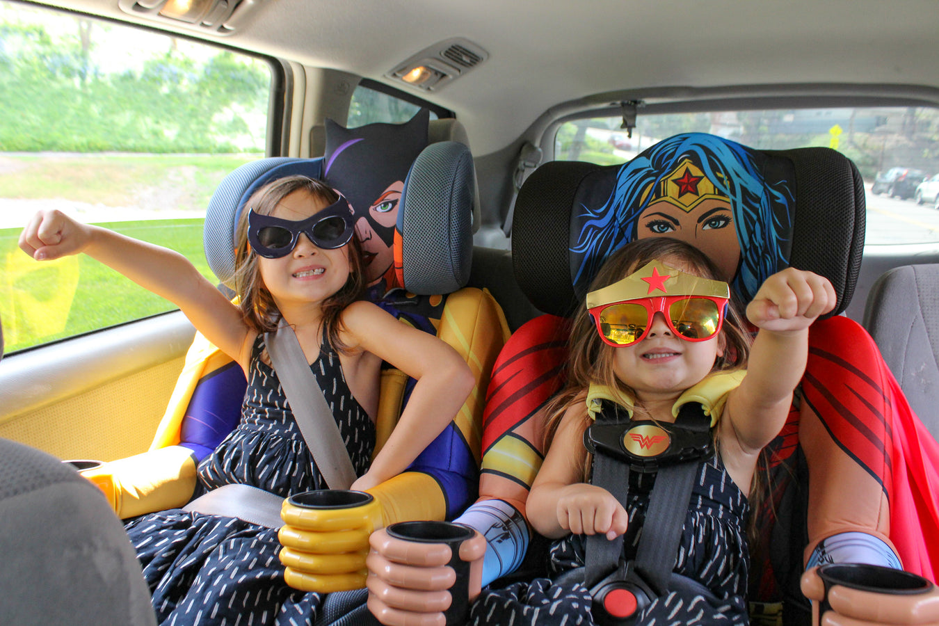 Wonder Woman car seat with kids sitting in them.